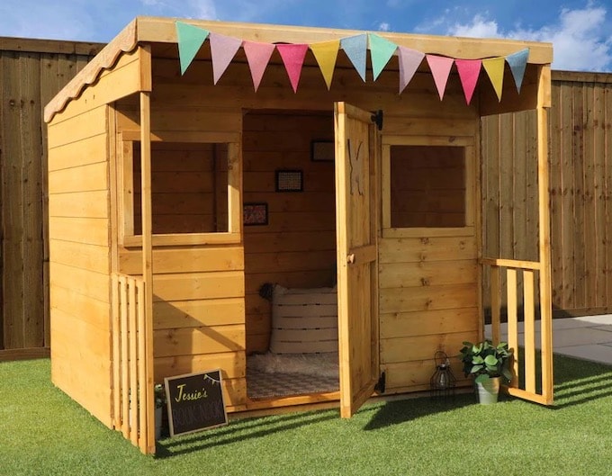 Dahlia wooden playhouse with bunting from Waltons