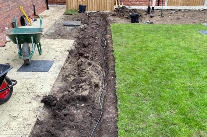 Trench in garden with cabling