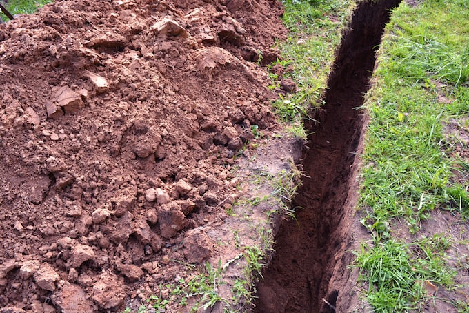 Trench in ground for water pipes