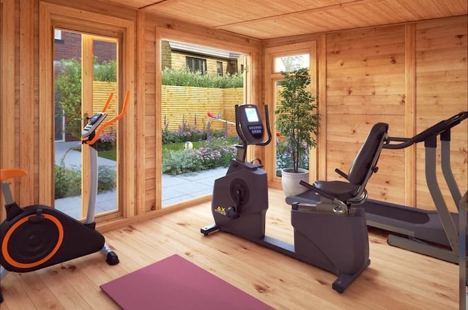 Exercise equipment inside garden gym with yoga mats