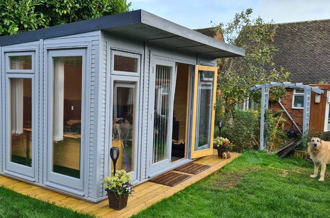 Garden overview with Waltons Insulated Garden Room with dog