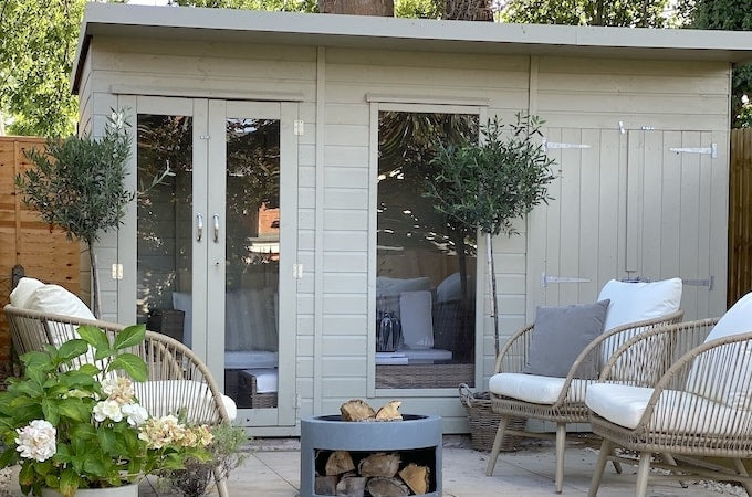 Sand coloured summerhouse with matching olive trees