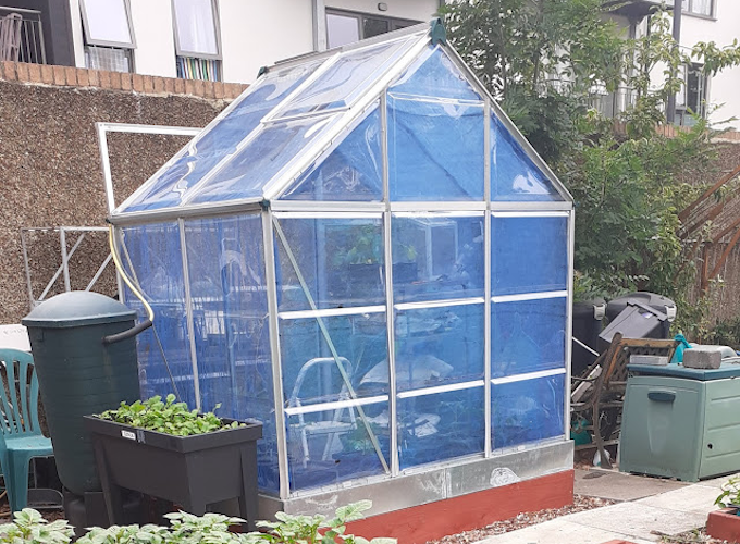 Blue greenhouse with interior shades