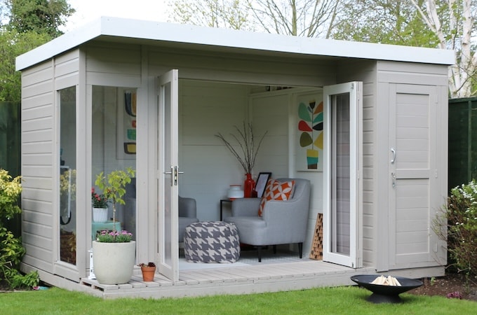 Grey painted summerhouse with mid-century interior decor