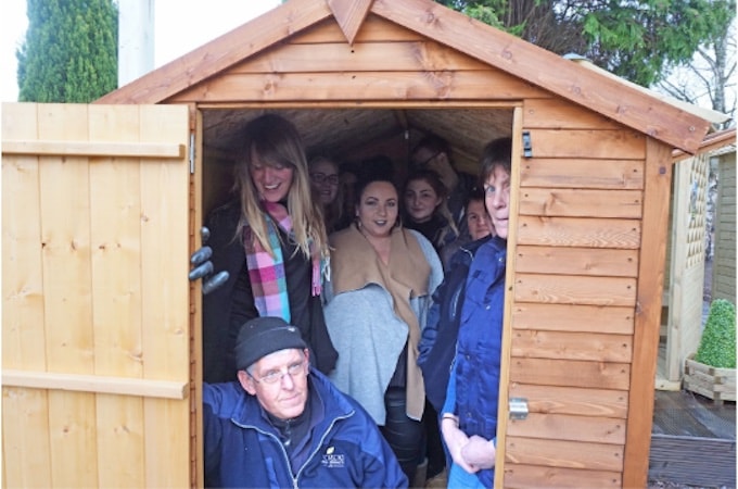 Group of people inside wooden Waltons shed