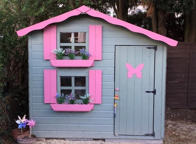 Painted grey and pink two-storey Waltons playhouse with butterfly decal