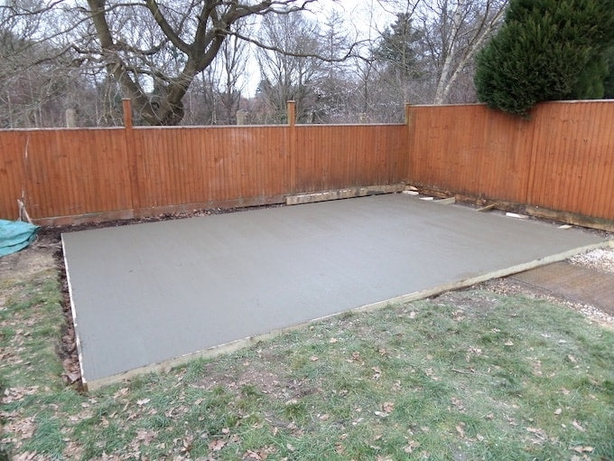 Dry concrete base before shed gets installed