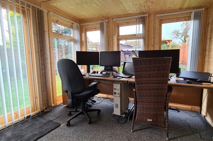 Interior of Waltons Insulated Garden turned home office with carpets, double desk and window blinds