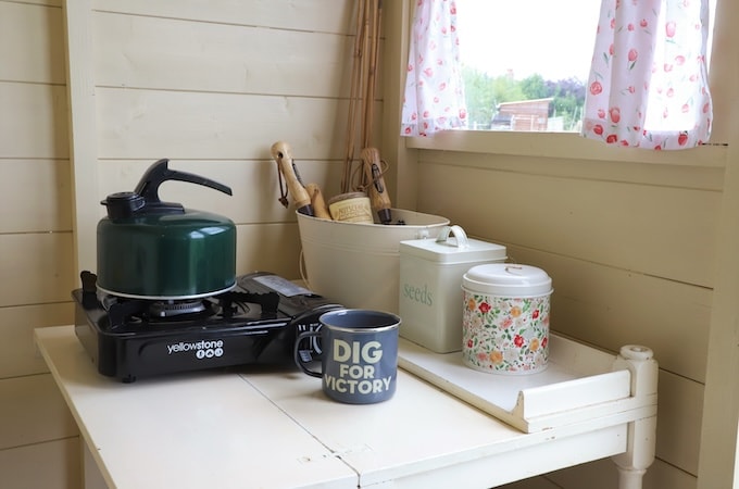 Interior of allotment shed with kettle and mug