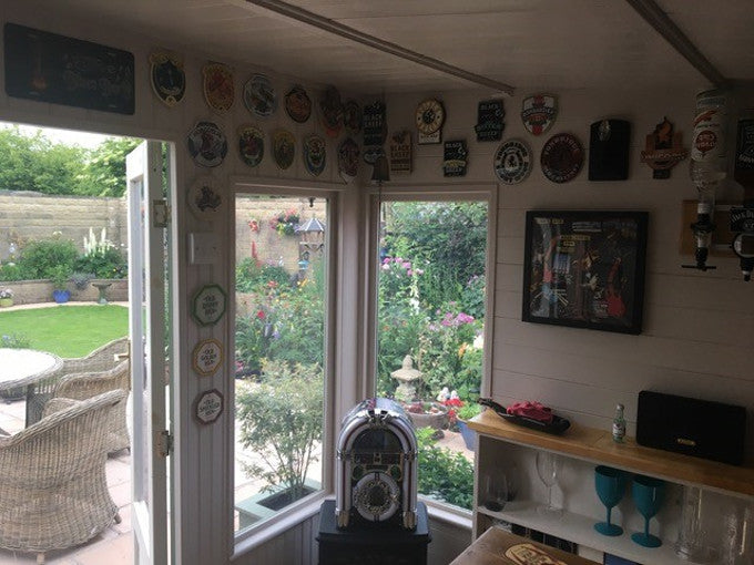 Pub paraphernalia inside decorated summer house