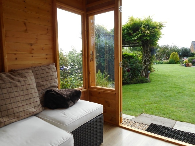 Interior photo of a Waltons wooden summer house with white sofa
