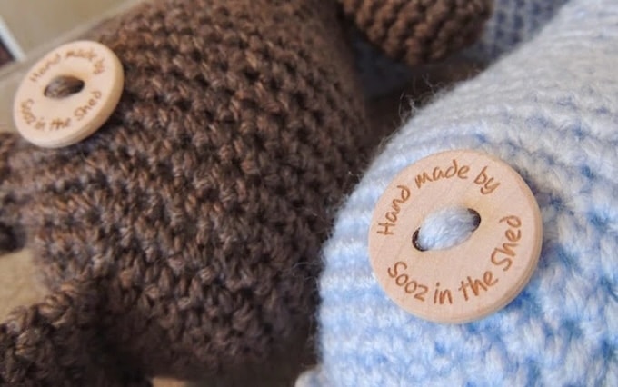 Two knitted bears with handmade wooden buttons