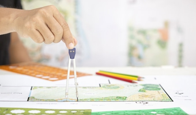 Person looking over garden plans