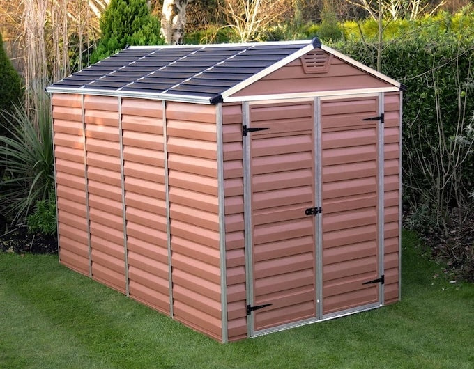 Amber coloured plastic shed in garden