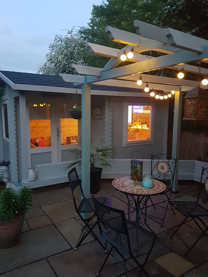 Outdoor entertaining space in garden near log cabin