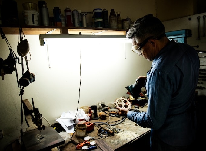 Man working in workshop with strip lighting