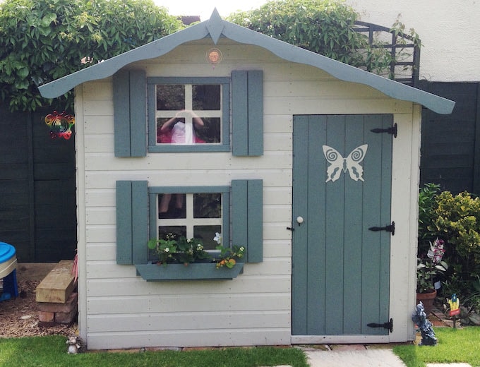 Blue and white two storey Waltons playhouse with butterfly door and window boxes