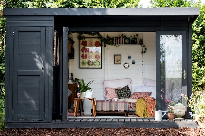 Overview of painted summerhouse turned chic tea shed