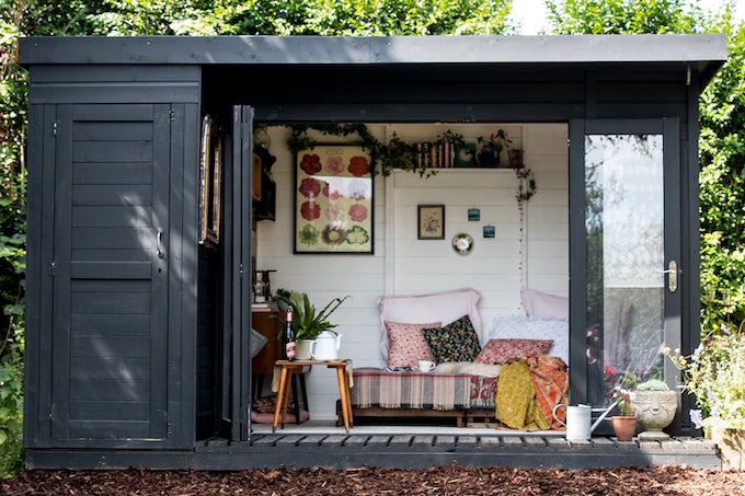 Painted shed with side storage and colourful soft furnishing