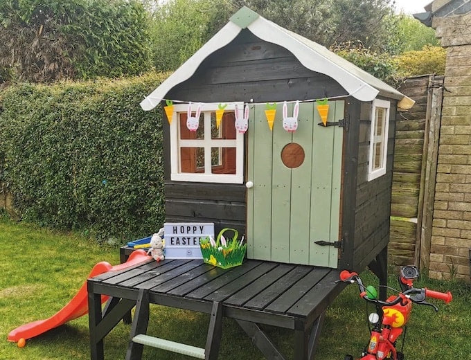 Painted Waltons wooden playhouse with Easter decorations