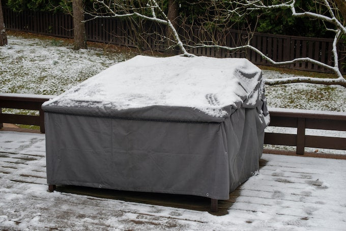 Patio furniture covered in snow