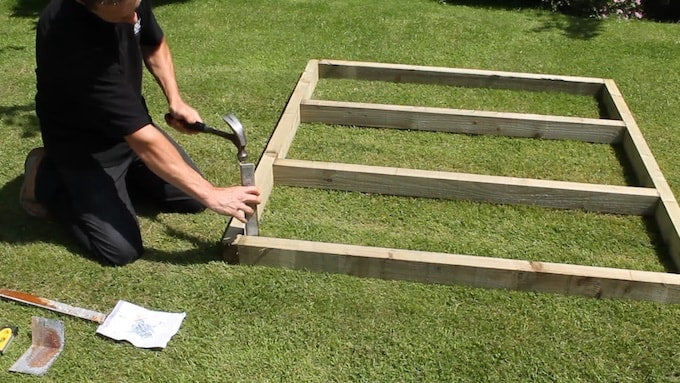 Constructing a wooden shed base on grass