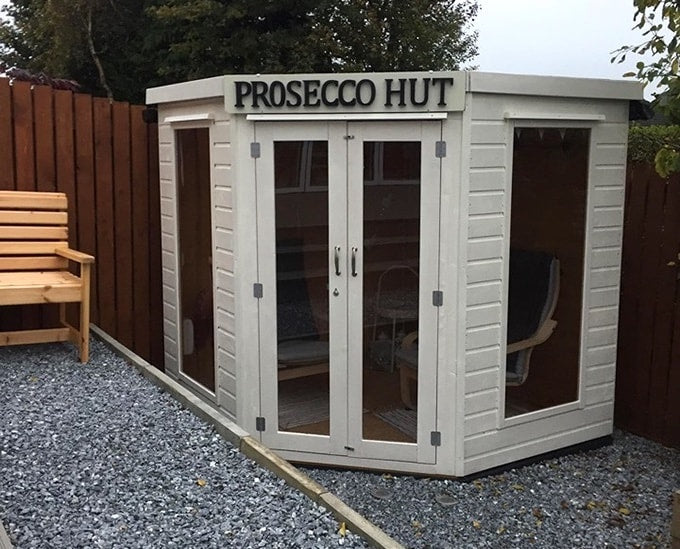 White Waltons summer house with sign saying 'Prosecco Hut'