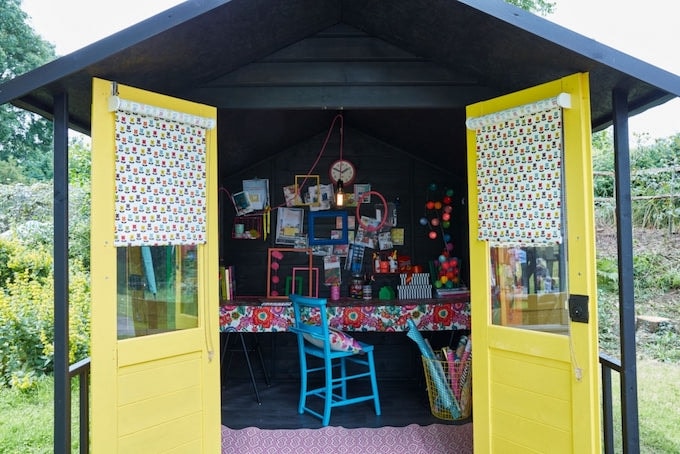 Black shed with yellow doors