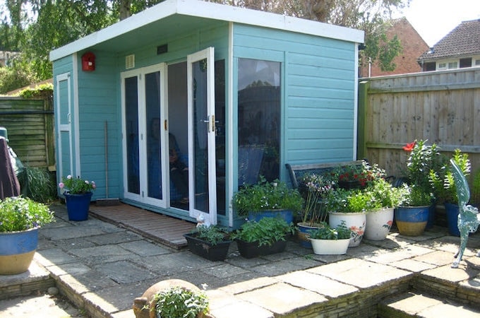 Side view of blue painted summerhouse