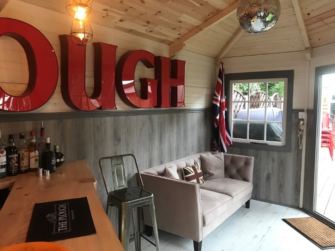 Grey sofa in garden log cabin
