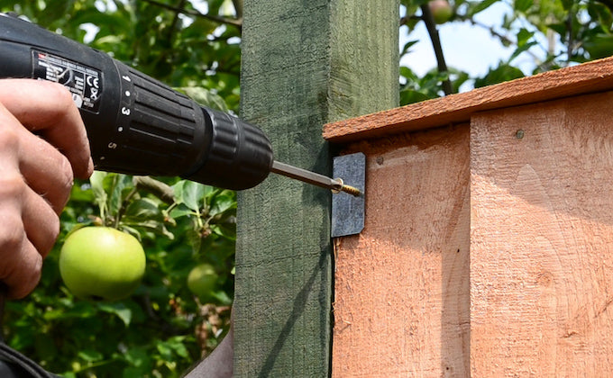 screwing fence panel to attachment clip