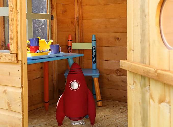 Inside view of a Waltons Snug playhouse with rocket ship toy