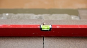 Spirit level being used to level out slabs