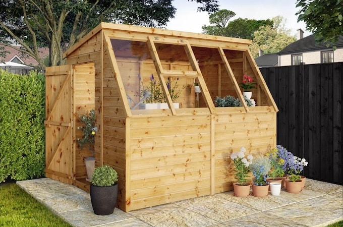 Potting shed wooden greenhouse in garden