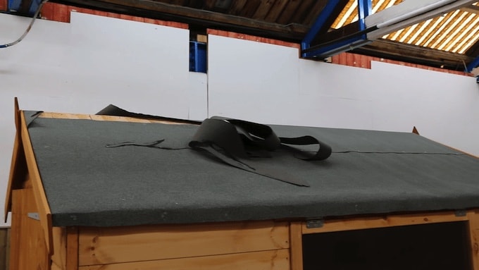 Damaged roof felting on a wooden shed