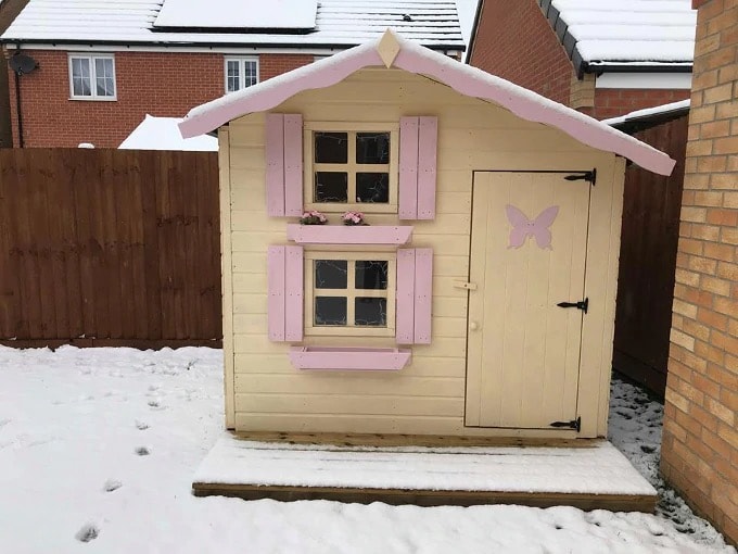 Cream and pink Snowdrop playhouse in snow