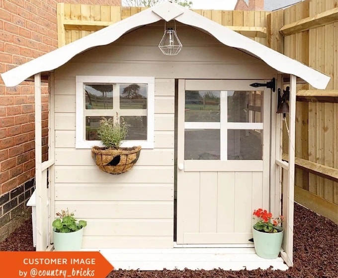 White playhouse with flower box