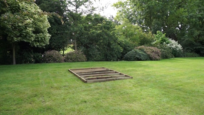 Wooden shed base on grass