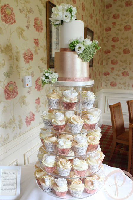 Small rose gold wedding cake with layered cupcakes