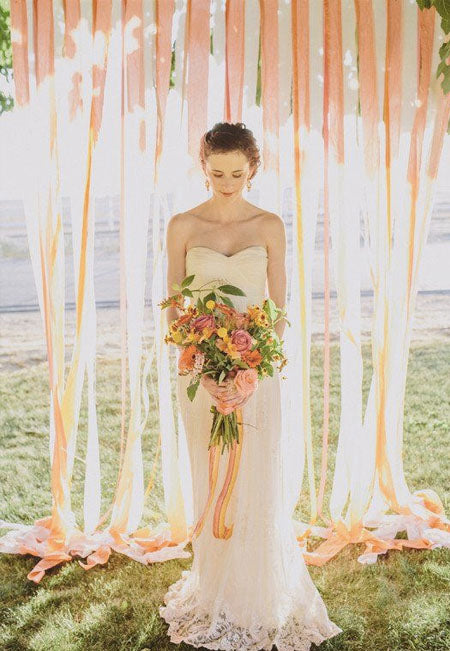 coral and peach yellow ribbon decorated wedding backdrop