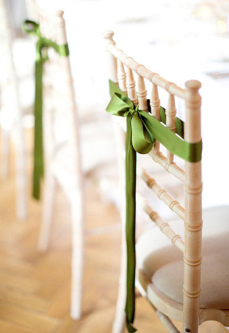 hunter green ribbon bow tied on the back of wedding chairs