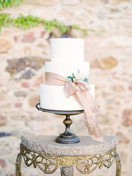 ribbon tying wedding cake for outdoor small garden wedding