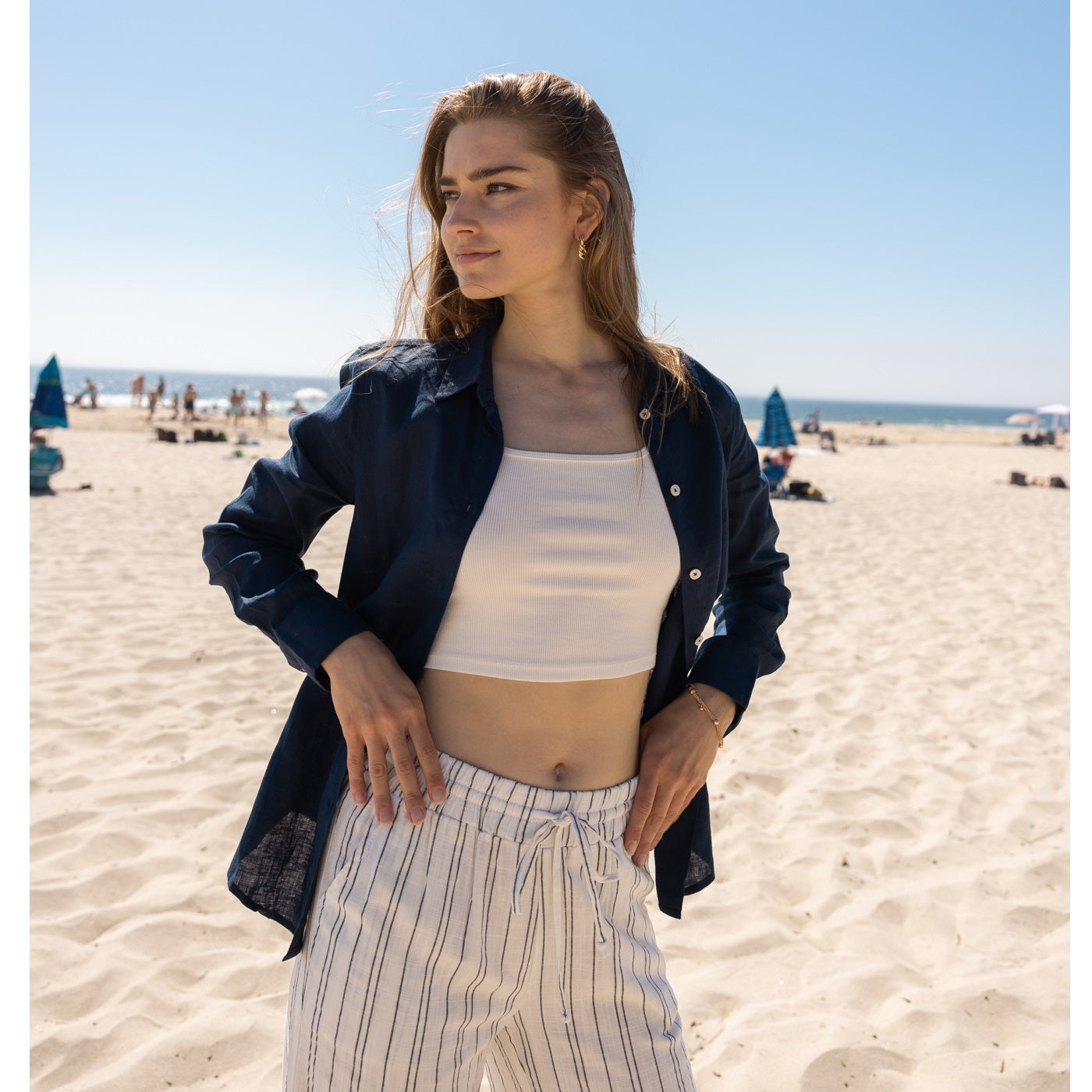 A woman wearing a linen top and pants at the beach