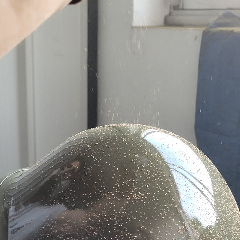 Crushed cork sprinkled on a US M1 helmet
