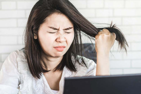 Woman in white shirt hair-pulling