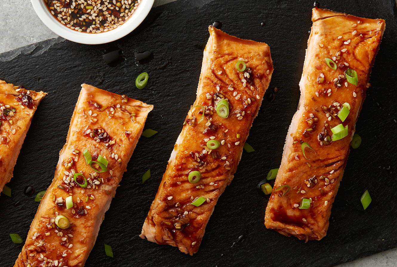 Baked salmon topped with green onion and sesame seeds.