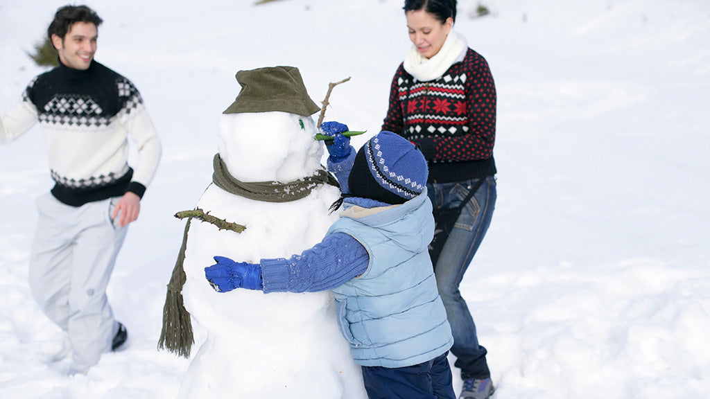 family building a snowman