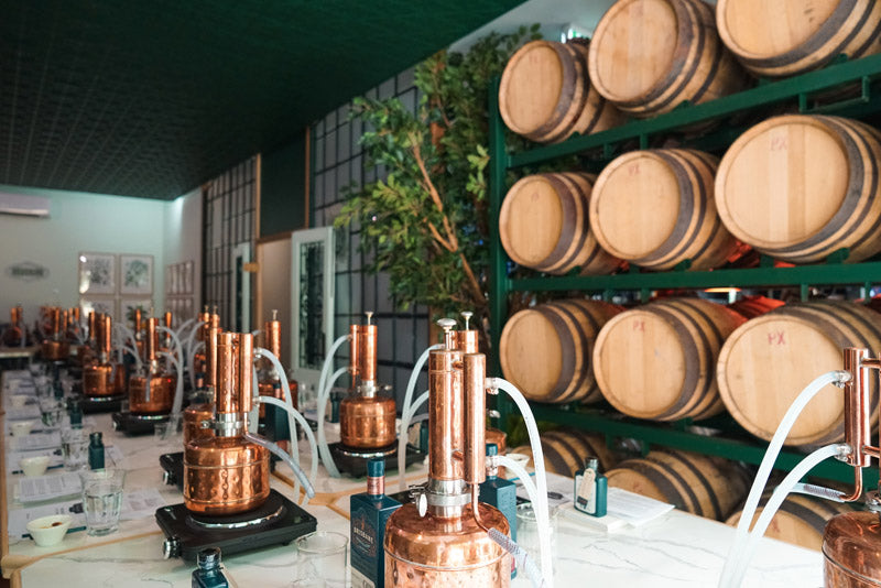 Inside Brisbane Distillery, showing gin barrels and distilling equipment