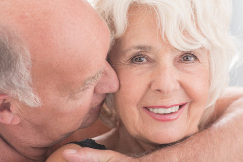 Man holds woman intimately around neck