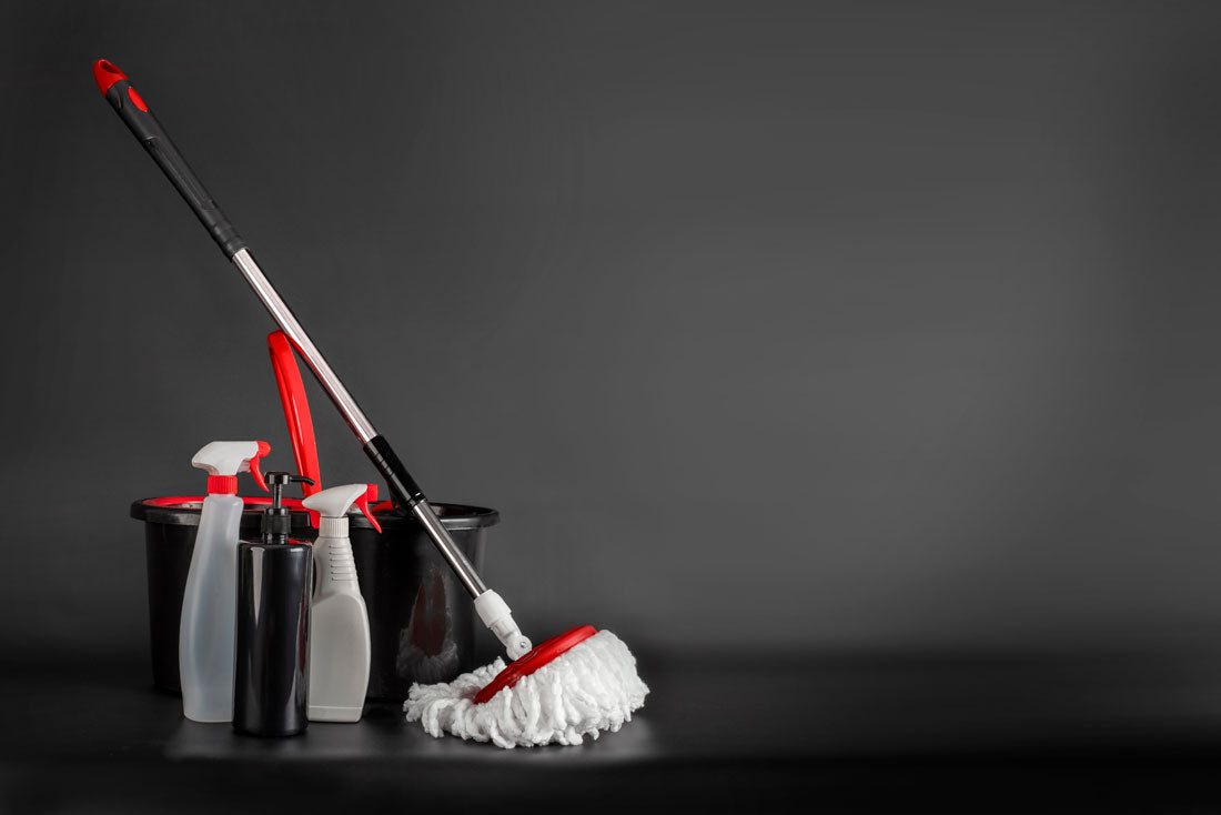 A spin mop, bucket, and cleaning supplies.